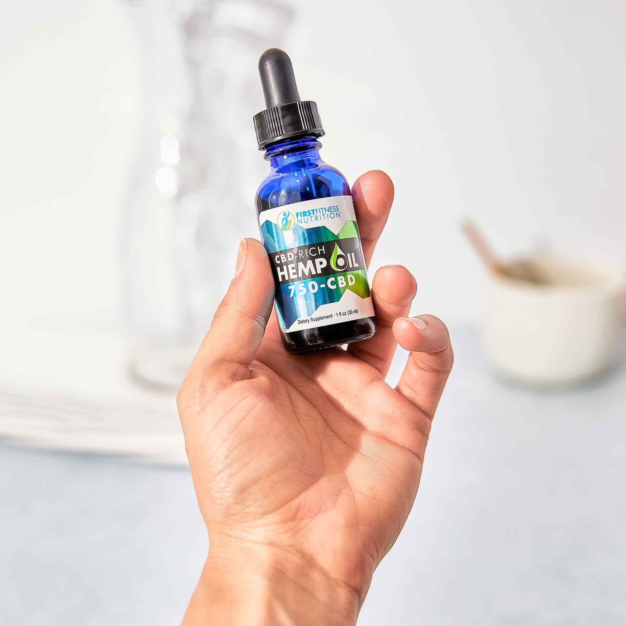 hand holding bottle of CBD
